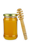 Glass jar with honey and wooden stick