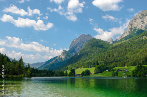 Hintersee lake against mountains in summer, distant boats