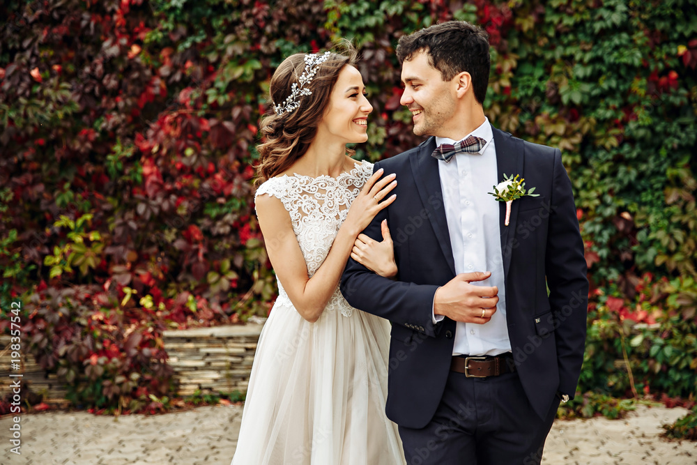 © matilda553 - Happy young bride and groom on their wedding day. Wedding couple - new family! wedding dress. Bridal wedding bouquet of flowers
