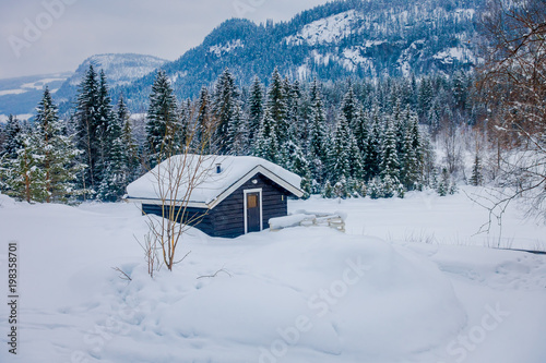 View of traditional mountain wooden houses covered with snow in stunning nature background in Norway © Fotos 593