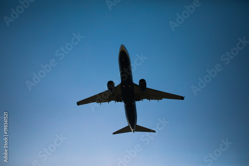 flying airplane in blue sky dusk