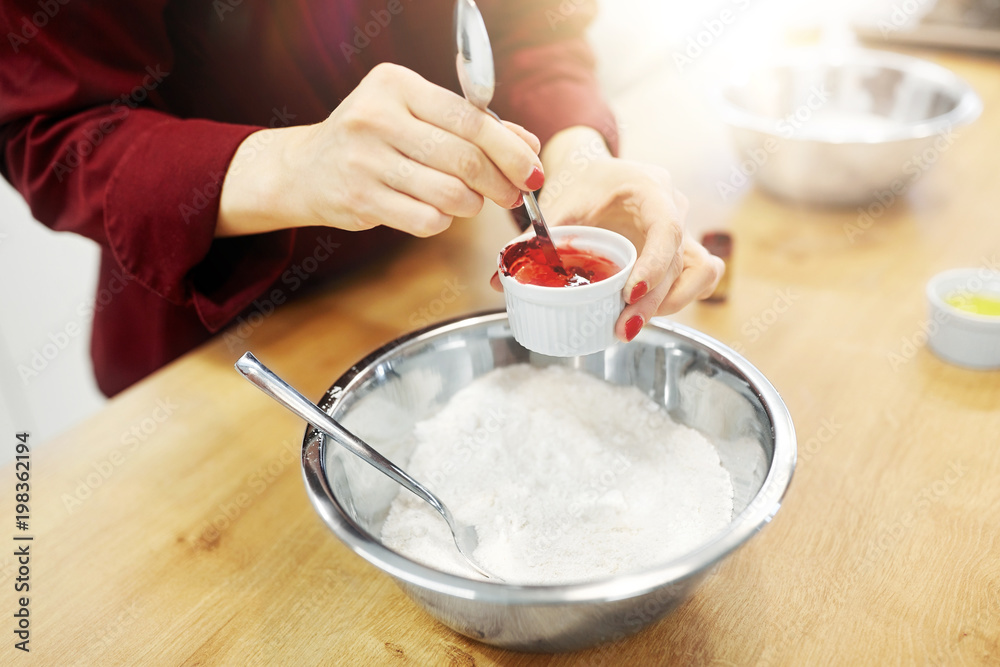 cooking, baking and people concept - chef hands with flour in bowl and food color additive making batter or dough cooking, baking and people concept - chef hands with flour in bowl and food color additive making batter or dough