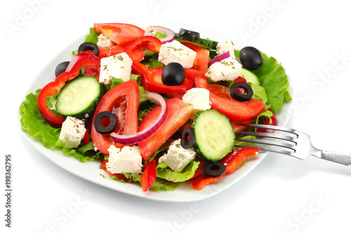 Square plate of greek salad isolated on white. fresh vegetable salad
