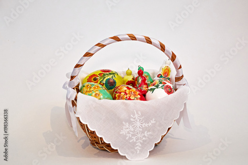 Easter eggs in a handmade basket of clay on a white background