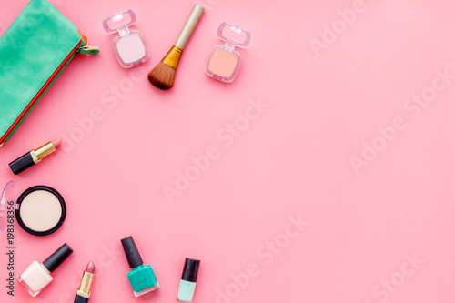 Women desk with decorative cosmetics for make up on pink background flat lay space for text