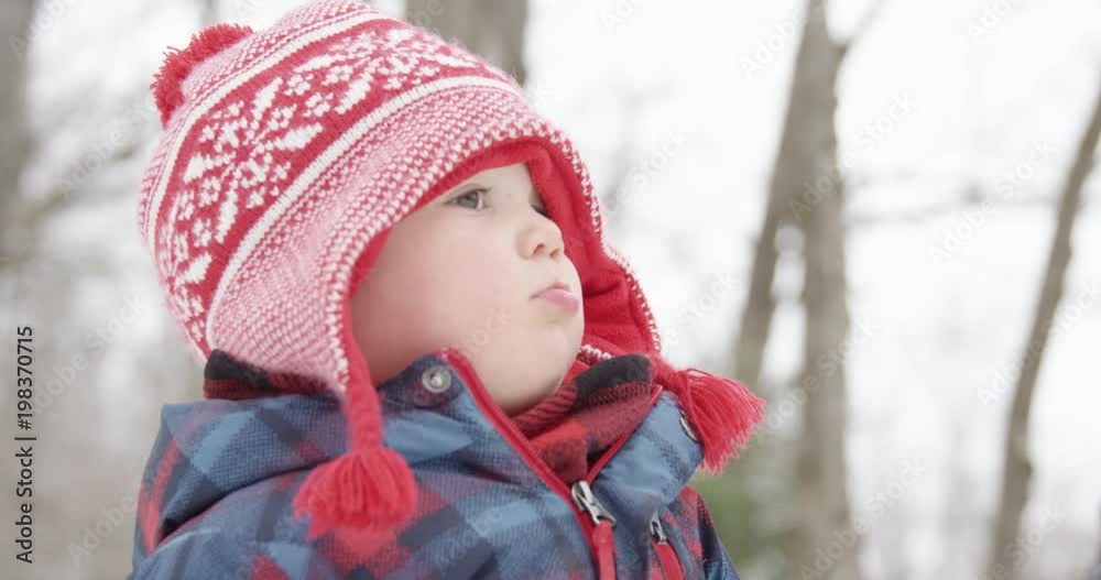 Toddler looking upset outdoors in winter - close up Toddler looking upset outdoors in winter - close up