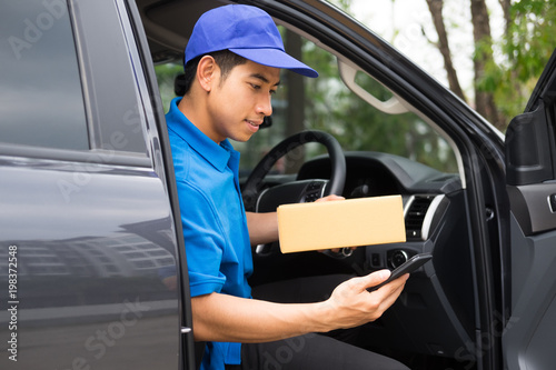 Delivery driver driving car with packages