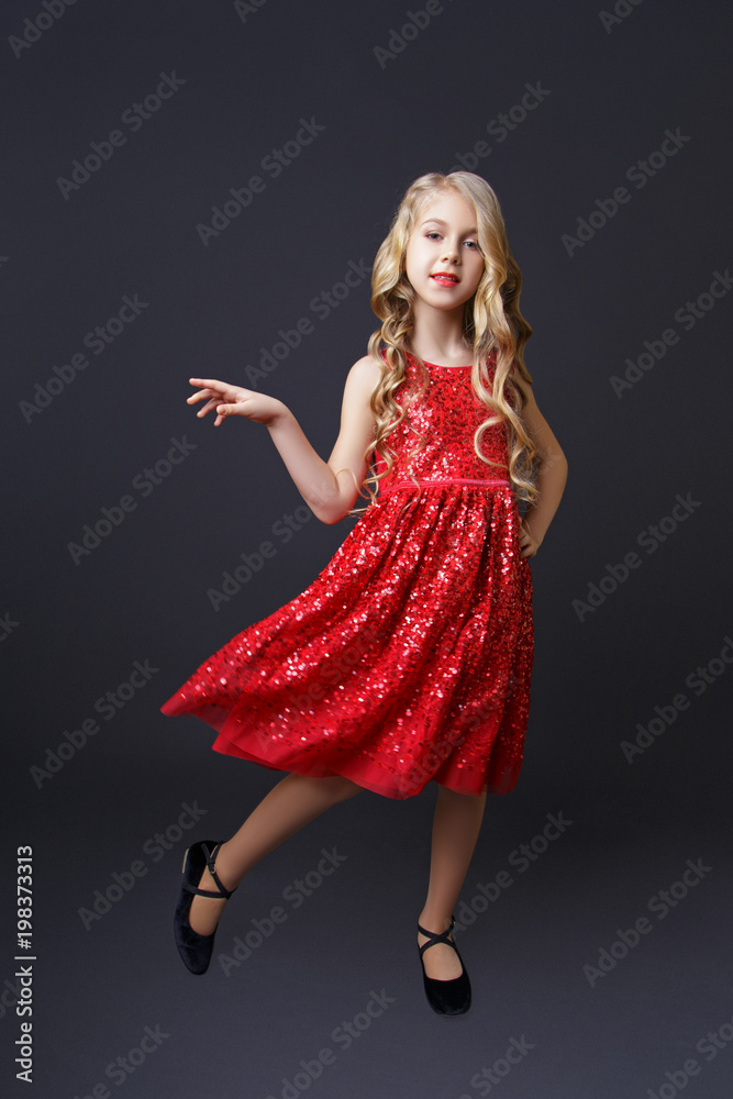 little girl blonde posing in studio on black background little girl blonde posing in studio on black background