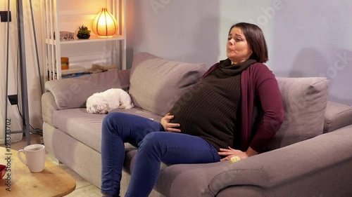 Beautiful pregnant woman feeling strong contractions asking for help calling husband medium shot