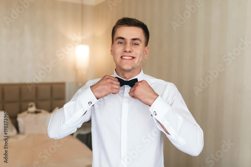 Smiling man with black bow tie photo