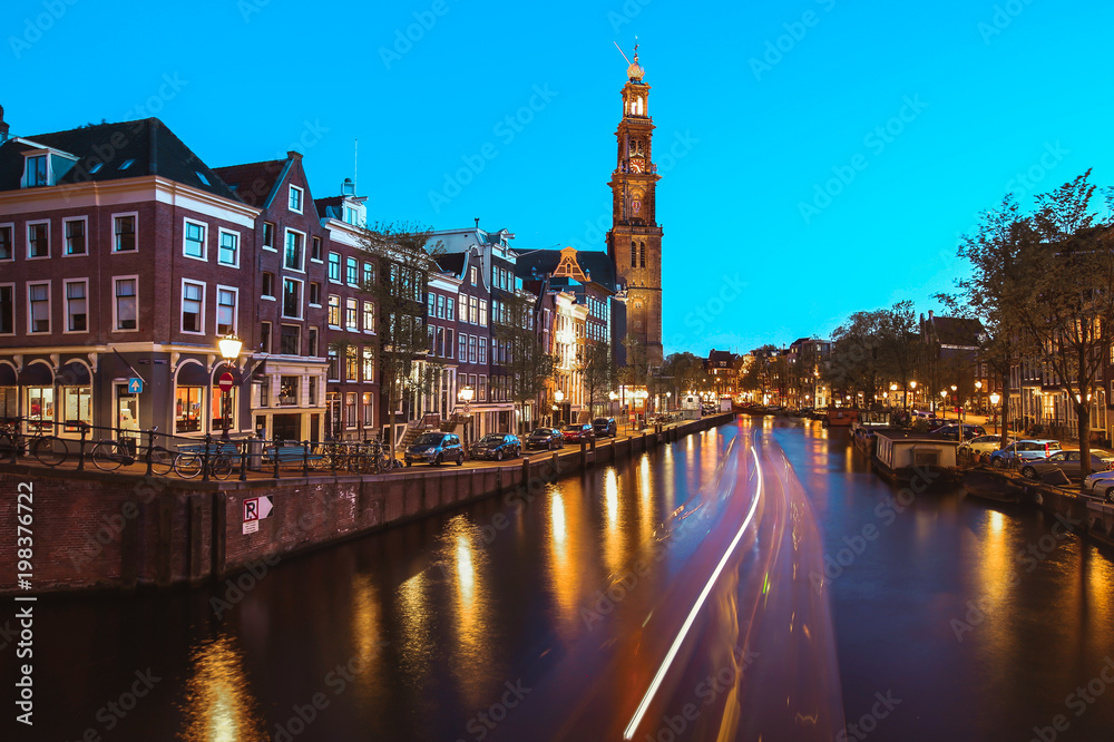 Fototapeta premium he Westerkerk Western Church along the Prinsengracht canal in Amsterdam at night