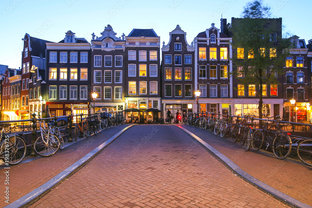 Traditional old buildings in Amsterdam at twilight, the Netherlands