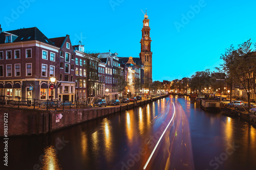 he Westerkerk Western Church along the Prinsengracht canal in Amsterdam at night
