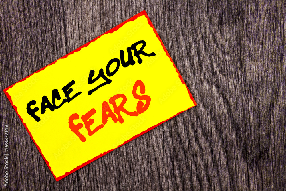 Conceptual hand writing text showing Face Your Fears. Concept meaning Challenge Fear Fourage Confidence Brave Bravery written on Yellow Sticky Note Paper on the wooden background. Conceptual hand writing text showing Face Your Fears. Concept meaning Challenge Fear Fourage Confidence Brave Bravery written on Yellow Sticky Note Paper on the wooden background.
