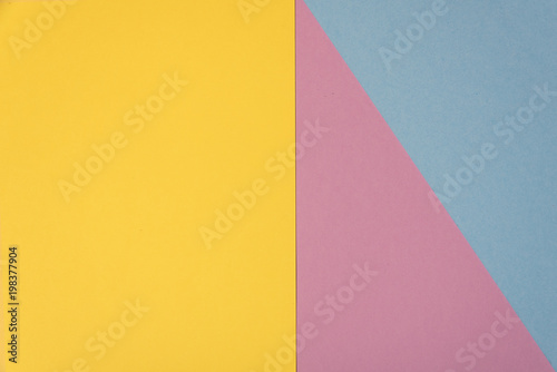 Colorful soft yellow, light blue and purple paper background.