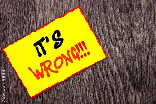 Conceptual hand writing text showing It Is Wrong. Concept meaning Correct Right Decision To Make Or Mistake Advice written on Yellow Sticky Note Paper on the wooden background.