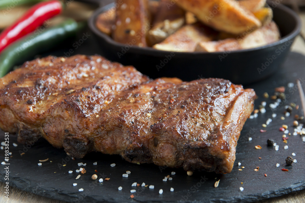 fried roasted pork ribs with potatoes and spices fried roasted pork ribs with potatoes and spices