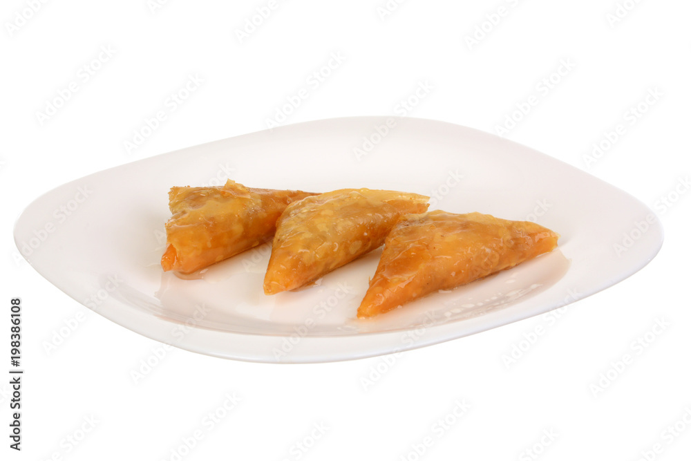 Three pieces of Baklava - an arabian sweet made with baked filo, stuffed with crushed nuts and basted with honey or sugar syrup.