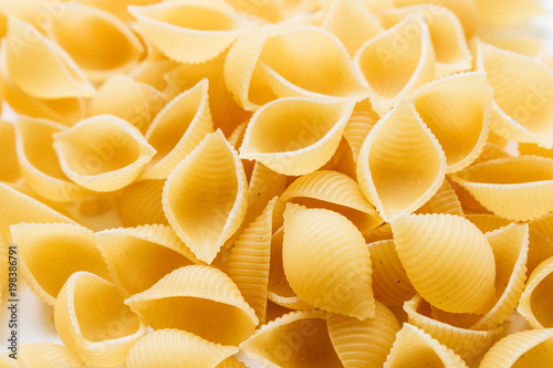 Pile of uncooked macaroni, food background