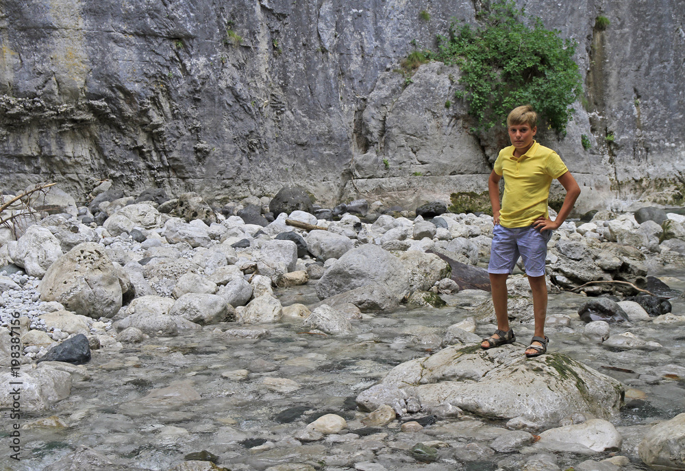 boy at river Iupshara in Abkhazia