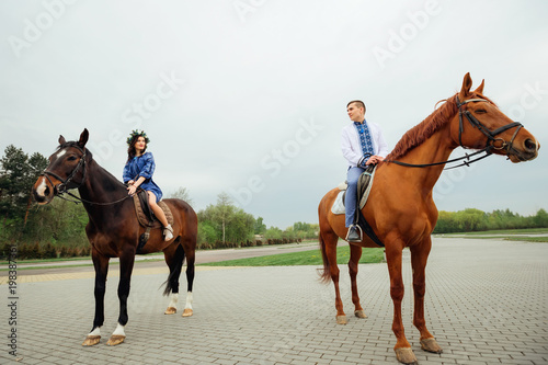  the girlfriend and her boyfriend who are sitting on horseback in the middle of the square and looking at each other