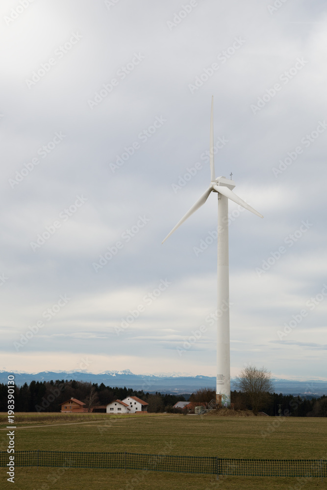 Fototapeta premium windmill for renewable electric energy production with Alps in the background