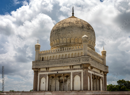 Qutb Shai tombs in Hyderabad India on a sunny day with large clouds in the background