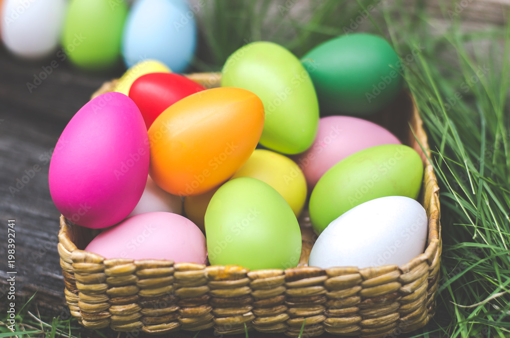 Easter eggs in grass against blurred green background. Spring holidays concept Easter eggs in grass against blurred green background. Spring holidays concept