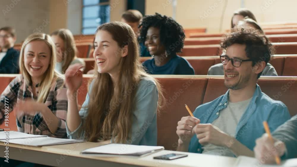 Multi Ethnic Group of Students Writing Down after Lecturer Start Laughing. Bright Young People Having Fun in the University.  Shot on RED EPIC-W 8K Helium Cinema Camera.