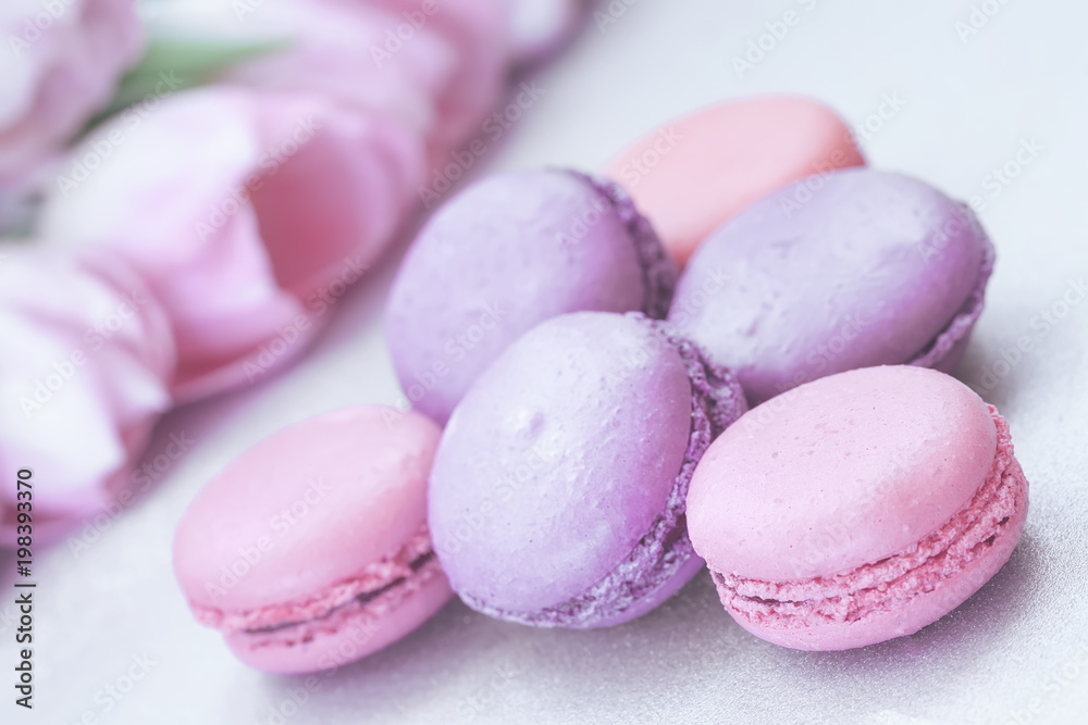 Pink and violet Macaroons close-up, spring flowers, tulips, tender pastel background. Romantic morning, gift for beloved Pink and violet Macaroons close-up, spring flowers, tulips, tender pastel background. Romantic morning, gift for beloved