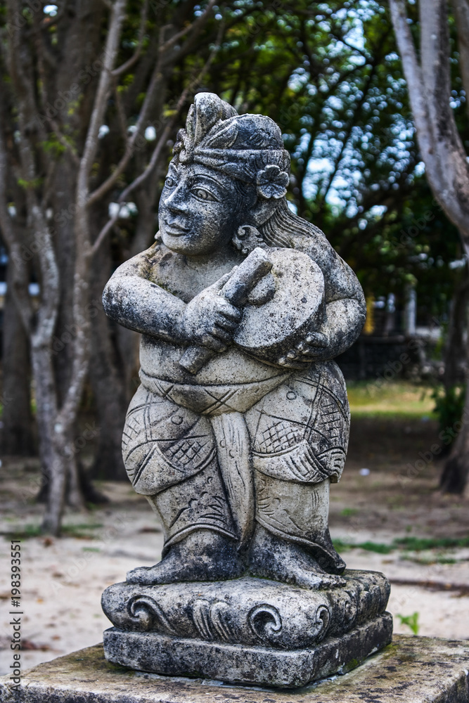 Stone statue near Pura Segara Desa Adat in Kuta, Bali, Indonesia