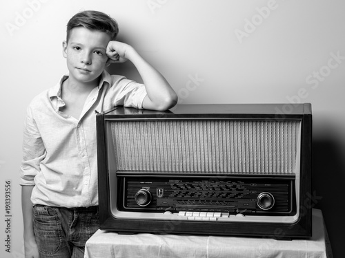 Boy teenager near old radio.