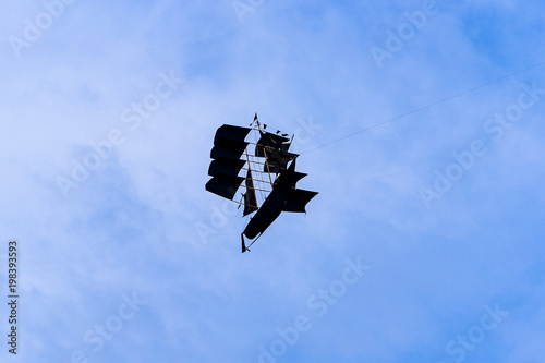 Kite on the blue sky looks like ship