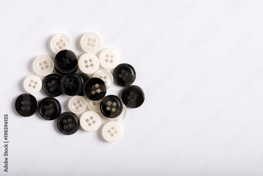 Buttons for clothes on a white background, top view. Buttons for clothes on a white background, top view.