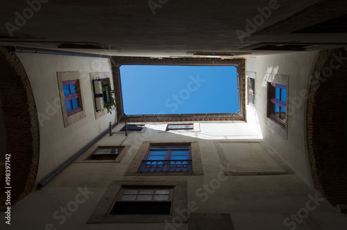 Straight up view of the sky from under archway in Alfama, Lisbon