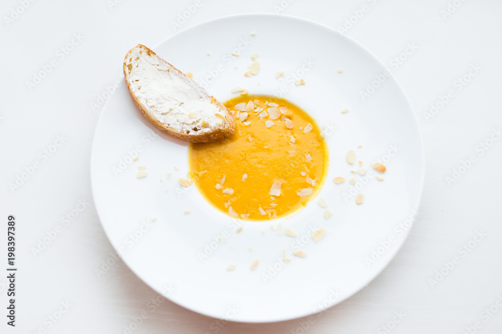Onion cream soup with toast. Vegetable cream soup with pumpkin in a white bowl and a slice of bread with cheese. Healthy food. Healthy diet meal. Onion cream soup with toast. Vegetable cream soup with pumpkin in a white bowl and a slice of bread with cheese. Healthy food. Healthy diet meal.