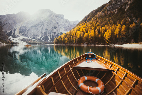 Old rowing boat on a lake in the Dolomites in fall