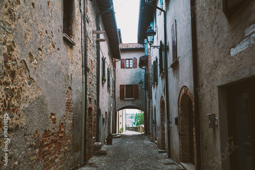 old narrow alley in tuscan village - antique italian lane in Montalcino, Tuscany, Italy. © Elizaveta