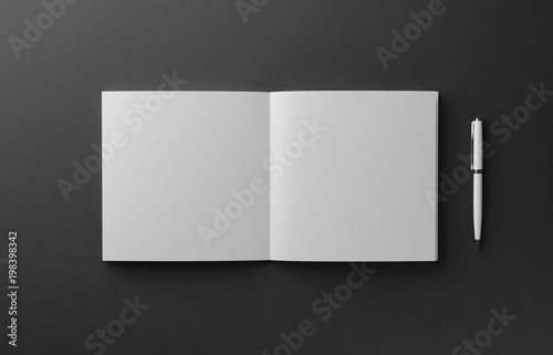 Blank photorealistic booklet with pen mockup isolated on black background, 3D illustration.