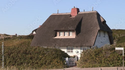 Traditional north German house with thatched rooves near town of Hörnum, Sylt, Germany. photo