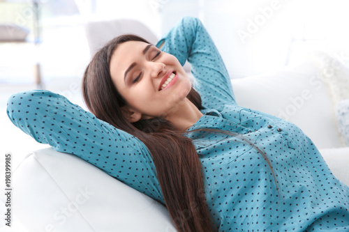 Young woman resting on sofa...