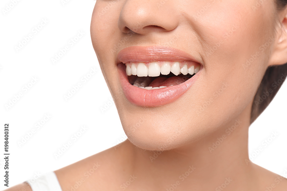 Young woman with beautiful smile on white background, closeup. Teeth whitening Young woman with beautiful smile on white background, closeup. Teeth whitening