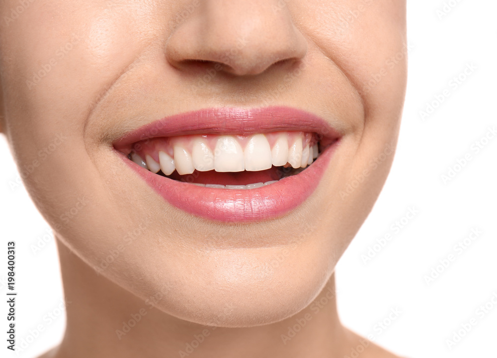 Young woman with beautiful smile on white background, closeup. Teeth whitening Young woman with beautiful smile on white background, closeup. Teeth whitening