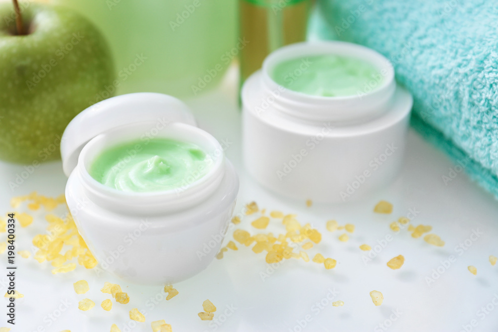 Jars with body care cream on table Jars with body care cream on table