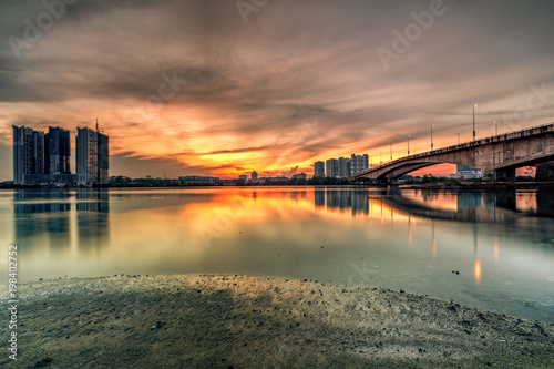 A long exposure picture of beautiful burning sunset under the bridge © hamdie