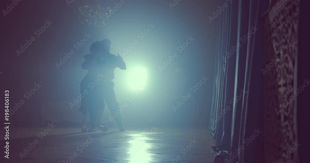 Silhouette of girl in black dress and man in black suit dancing tango Silhouette of girl in black dress and man in black suit dancing tango