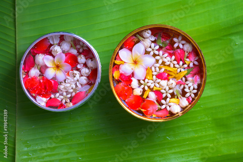 Colorful flower in water bowls decorating on Banana leaf for Songkran Festival or Thai New Year