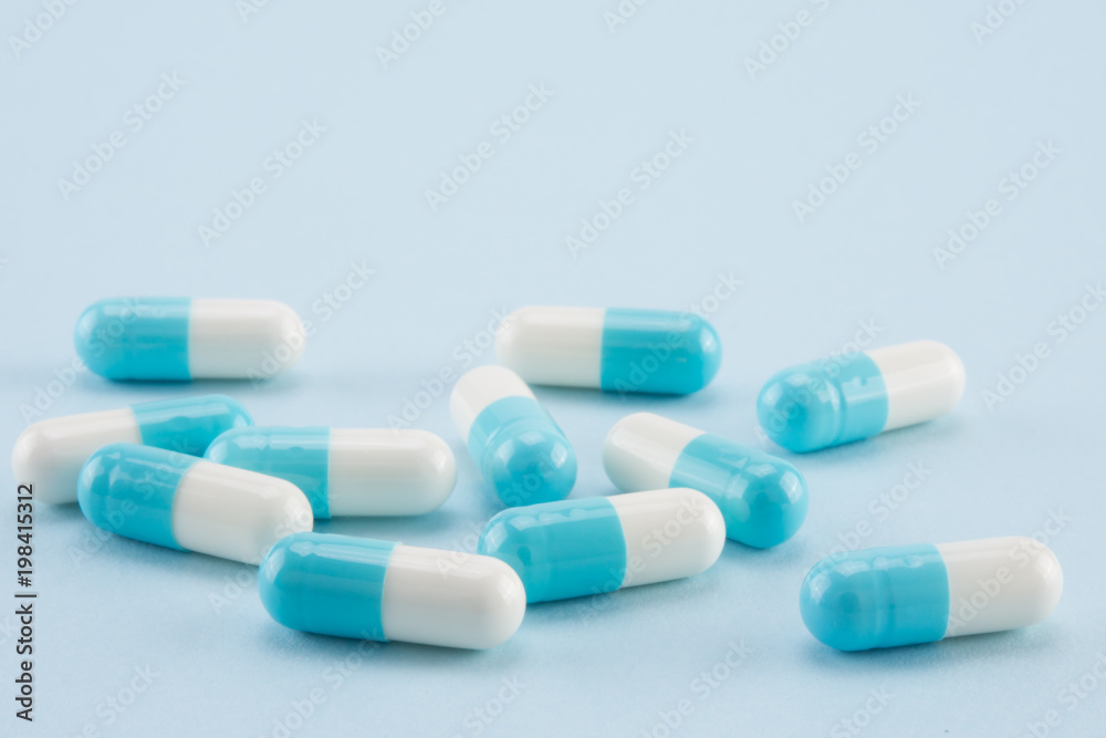 capsules of medicine on blue background