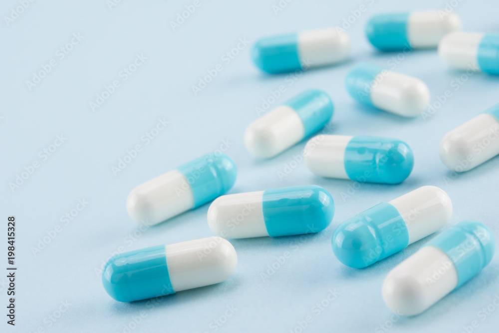 capsules of medicine on blue background