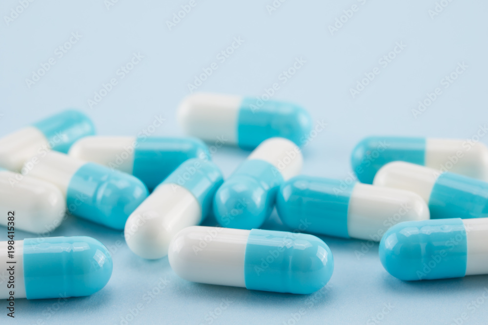 capsules of medicine on blue background capsules of medicine on blue background